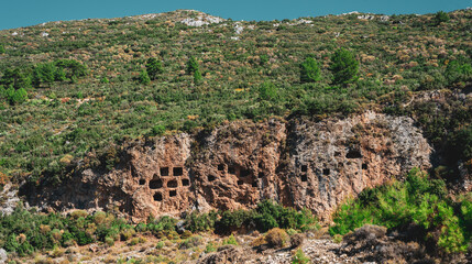 Ruins of the rock tombs of the ancient city, in the mountains of Turkey, Antalya