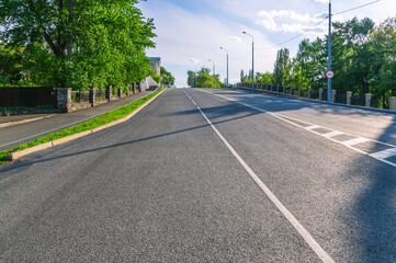 Paved road in the city. New asphalt road surface. There are road markings on the road.