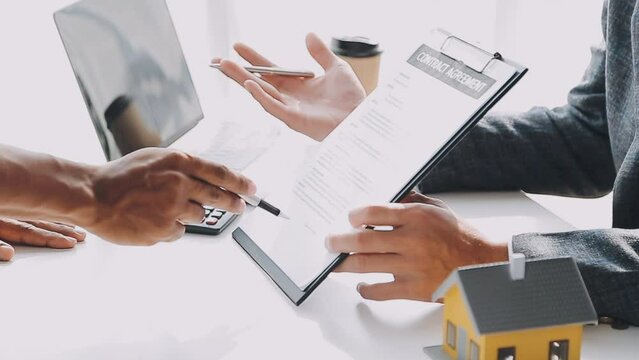 Real estate brokerage agent Deliver a sample of a model house to the customer, mortgage loan agreement Making lease and buy and sell house And contract home insurance mortgage loan concept