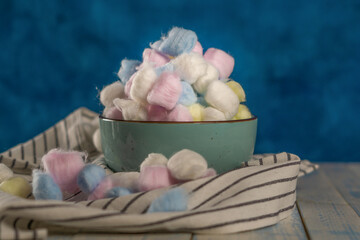 colored cotton balls on a blue background