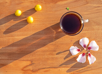 good morning, infusion of chicory with hibiscus flowers with crumbs on a wood background, horizontal