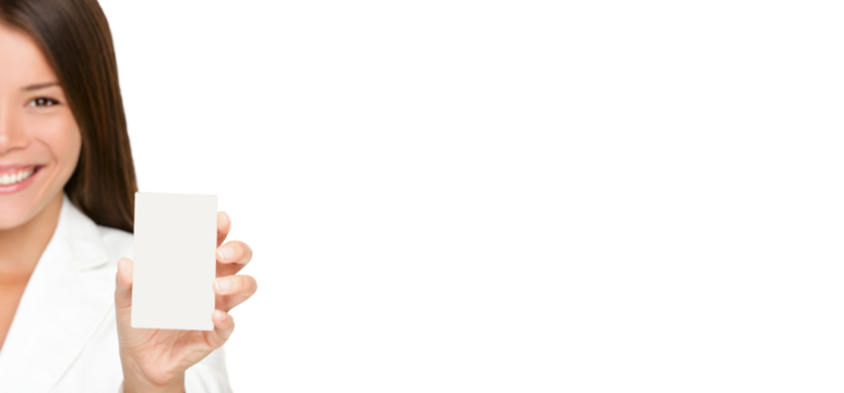 Woman showing business card. Businesswoman in suit holding blank card sign. Can be replaced with smart phone. Asian / Caucasian business woman isolated cutout PNG on transparent background in suit.