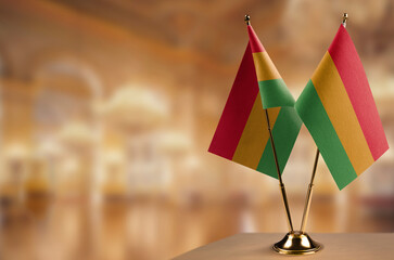 Small flags of the Bolivia on an abstract blurry background