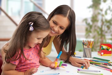 Happy mom helping child to study at home