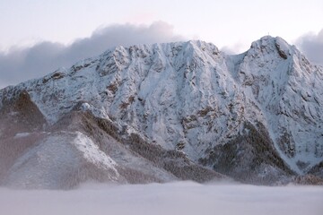 Winter scenery of panorama of Tatras Mountains with characteristic Giewont peak with cross, and clouds under them from Gubalowka hill in Zakopane, Podhale, Poland