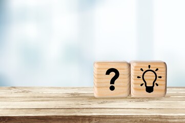 Question mark with lamp bulb on wooden cubes