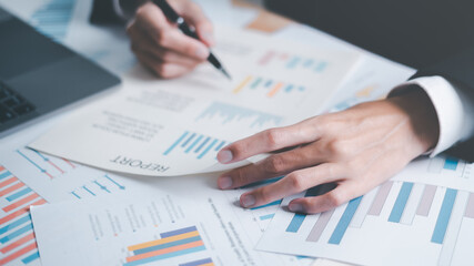 Analyst read business statistics chart reports, to analyze and improve corporate strategy, manage financial and marketing documents, update annual budget accounts, business data analysis concept