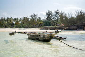 Traditional wooden fishing boat on the beach in Zanzibar