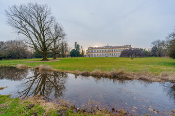 Fototapeta na wymiar Villa Reale building, lawn, trees, and water stream, Monza Park
