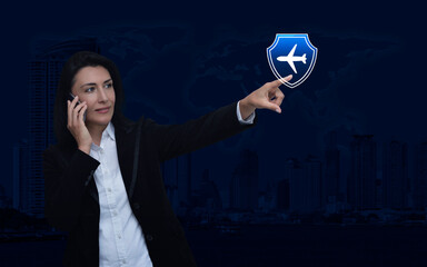 Businesswoman talking on her cell phone and pointing finger to airplane with shield icon over world map and city, Business travel insurance online concept, Elements of this image furnished by NASA