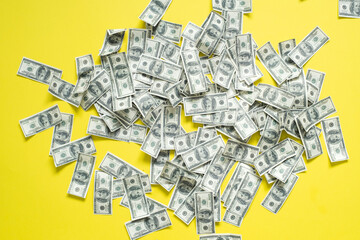 American cash banknotes money bills on a yellow background.