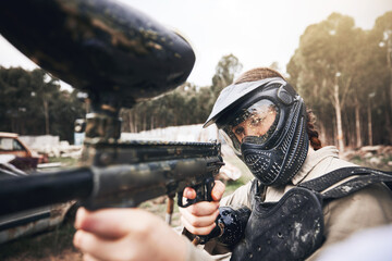 Paintball, gun and aim with a sports woman training for the military or army during a war and...