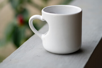 A Close-Up of a White Mug with Love Handle