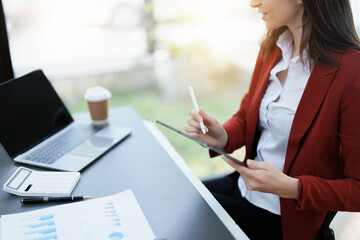 business owner or Asian female marketers are using tablet computer in office work