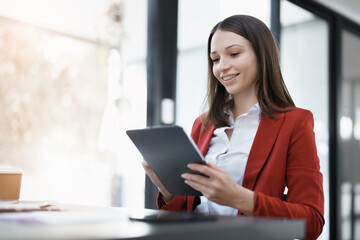 Fototapeta premium business owner or Asian female marketers are using tablet computer in office work