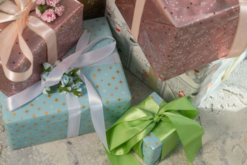 Many New Year's gifts in bright colored boxes under the Christmas tree