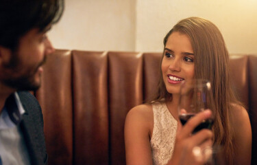 Couple, restaurant and valentines day date with wine glass, love and happy communication to celebrate. Young man and woman together for fine dining, drinks and romantic dinner for holiday celebration