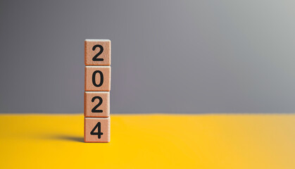 2024 New year goal planning idea concept, number in wooden block cubes. Gray and yellow background...