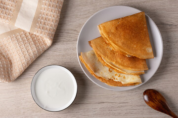 Russian pancakes or blini with sour cream . Top view. Pancake week. Shrovetide