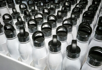 Easy-to- carry black plastic cap of white bottle in rows for pattern background.