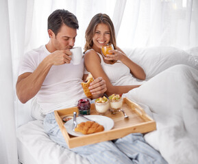 Breakfast, bed and couple portrait with love, care and morning food together at home. Happiness,...