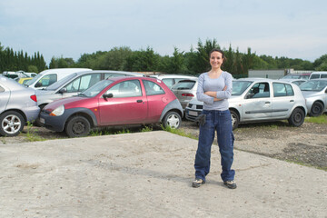 portrait of woman in vehicle scrapyard