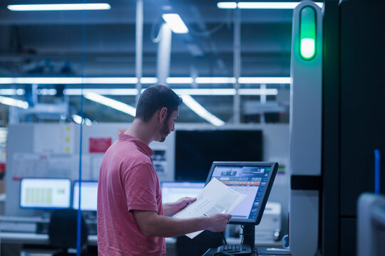 Man working in books printing industry, Bremgarten, Hartheim am Rhein, Baden-Wuerttemberg, Germany