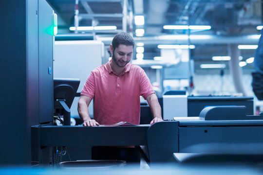 Man working in books printing industry, Bremgarten, Hartheim am Rhein, Baden-Wuerttemberg, Germany