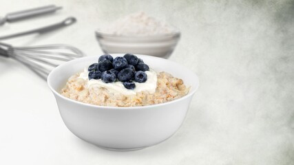 Oat flakes in the bowl. Tasty morning dish
