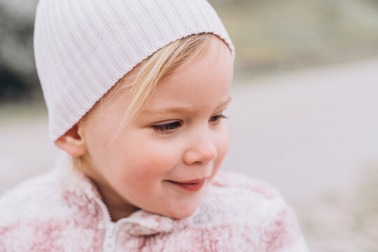 Ruddy child in the spring park, Nordic beauty