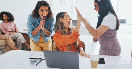 Obraz na płótnie Canvas Success, fist bump or happy employees with a handshake in celebration of digital marketing sales goals at office desk. Laptop, winner or excited women celebrate winning an online business deal at job