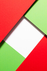 Square blank space under green and red card-stock that cast their shadows.