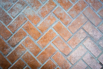 Old brick tiled pattern on a floor. Tile looking like a wall or floor style.