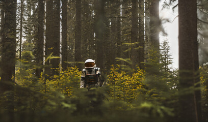 a man in an astronaut suit standing in a snowy forest - AI Generated