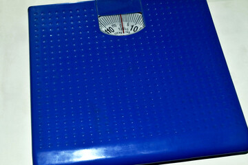 Blue floor household scales on a white background
