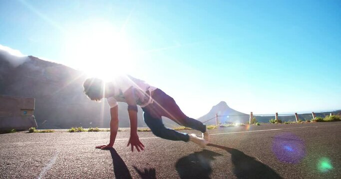 Teenager practicing some flexible breakdancing in a road in slow motion