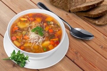 Tasty fresh soup dish in plate with bread