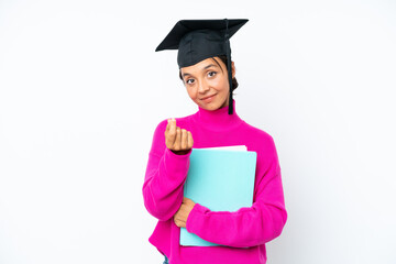 Young student hispanic woman holding a books isolated on white background making money gesture