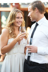 Wine, love and couple at a party, smile and happy while talking, flirting and bonding at an outdoor event. Champagne, romance and man with woman in romantic moment, first date or valentines day