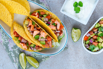 Grilled salmon tacos with avocado salsa