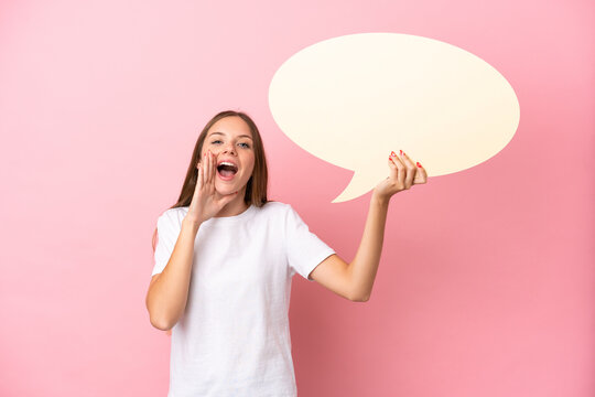 Young Lithuanian woman isolated on pink background holding an empty speech bubble and shouting