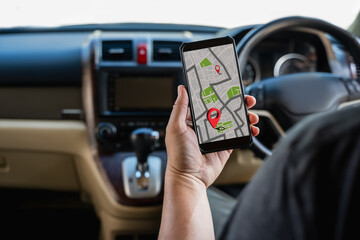 A man makes use of GPS and the internet. online map in the car controls the navigator for GPS tracking.