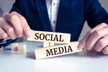 Obraz premium Close up on businessman holding a wooden block with 