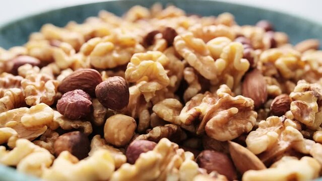 Nut mix of walnuts, hazelnuts and almonds bowl video 4k