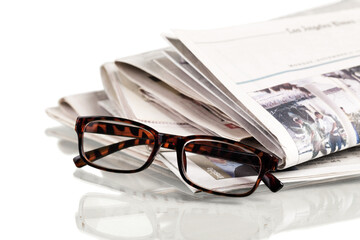 Closeup of Newspapers with Eyeglasses