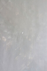 Gray concrete vertical wall background with spots