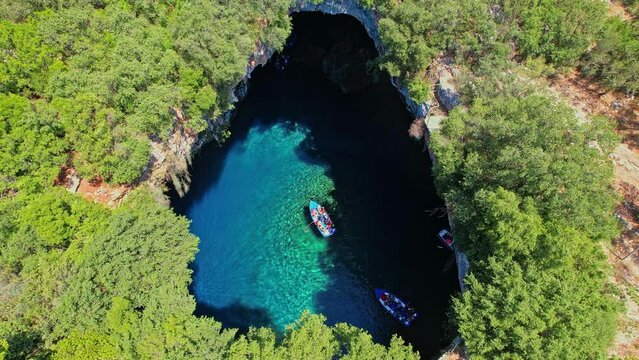 Aerial view of the  iconic Melissani cave with the crystal clear  turquoise waters located near port of Sami, Kefalonia island, Ionian, Greece