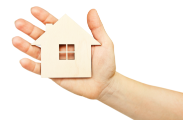 One little wooden house in the woman's hand