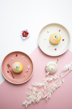 traditional Chinese vegetarian teochew crispy cute color pink and yellow yam mooncake on plate in white and pink color background