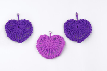 Colored crocheted yarn  hearts isolated on white background